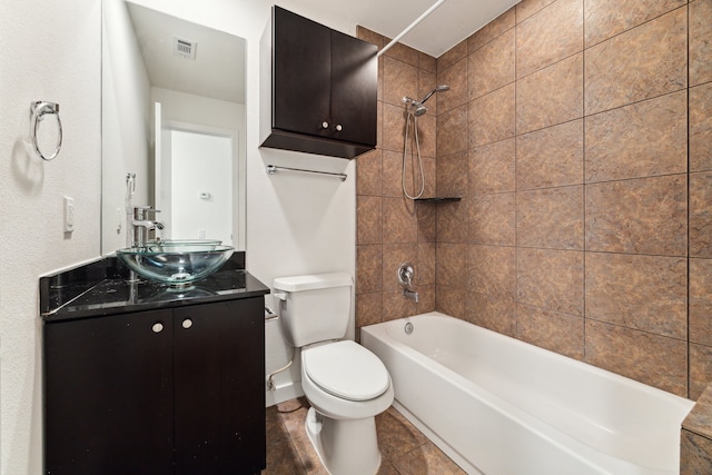 full bathroom with vanity, toilet, and tiled shower / bath