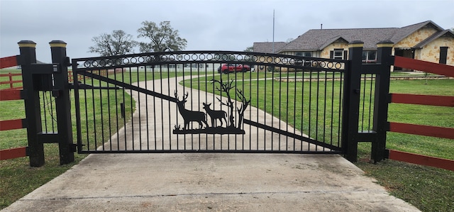 view of gate featuring a yard