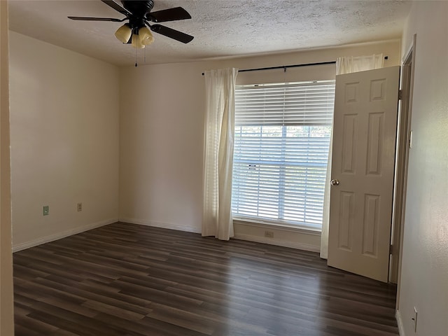 spare room featuring dark hardwood / wood-style floors, a textured ceiling, and ceiling fan