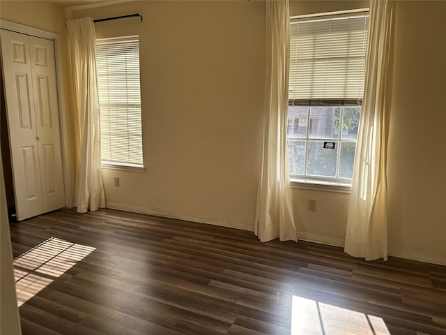 empty room featuring dark wood-type flooring