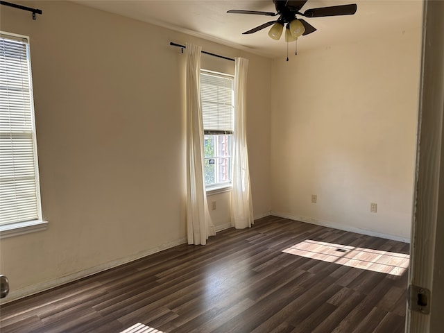 unfurnished room featuring dark hardwood / wood-style floors and ceiling fan