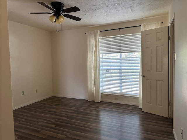 unfurnished room featuring a textured ceiling, dark hardwood / wood-style floors, and ceiling fan