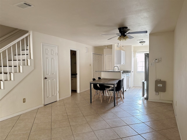 dining area with sink, ceiling fan, and light tile patterned floors