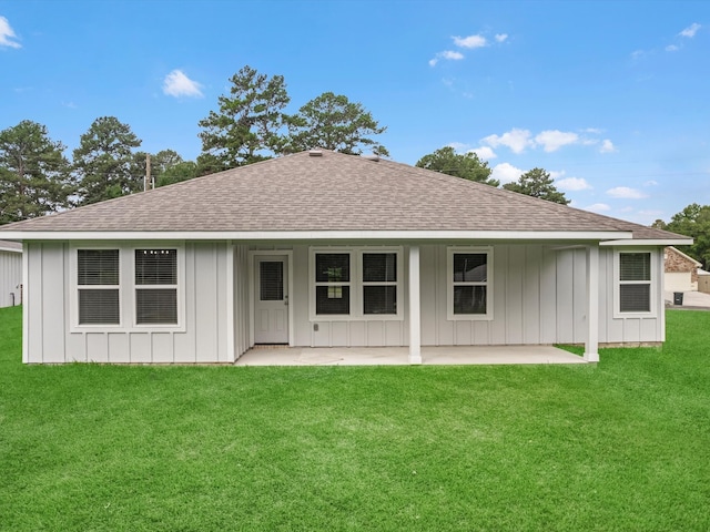 back of property with a patio and a yard