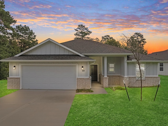 view of front of house with a yard and a garage