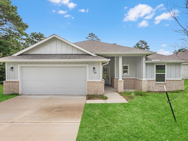 view of front of home with a front yard and a garage