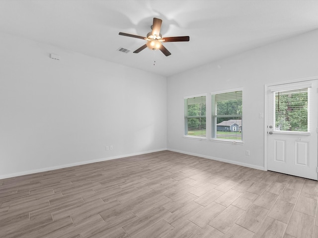 empty room with light hardwood / wood-style floors and ceiling fan