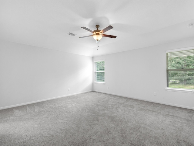 unfurnished room with carpet and plenty of natural light