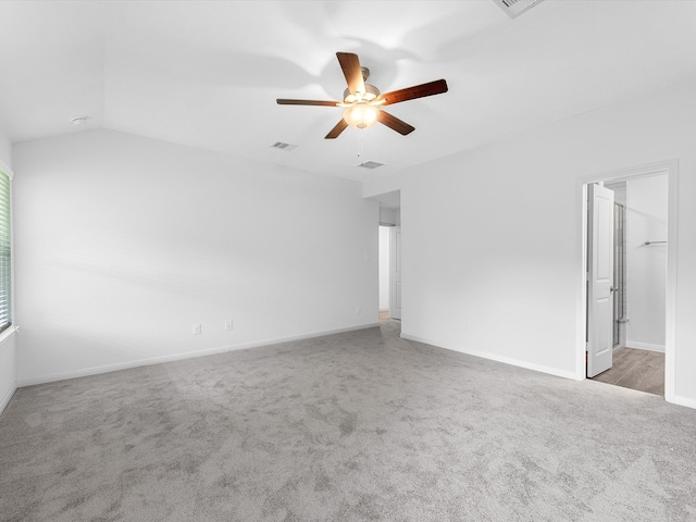 carpeted empty room featuring vaulted ceiling and ceiling fan