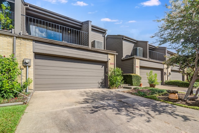 townhome / multi-family property with a garage and a balcony