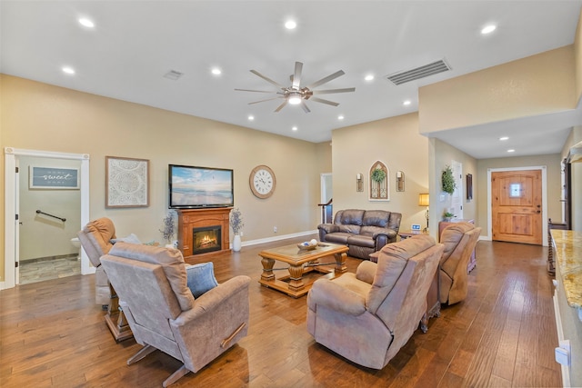 living room with ceiling fan and wood-type flooring