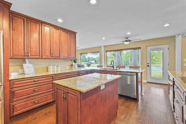 kitchen featuring a wealth of natural light, dishwasher, a kitchen island, and dark wood-type flooring