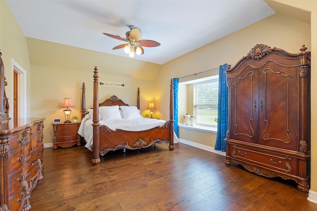 bedroom with ceiling fan, dark wood-type flooring, and vaulted ceiling