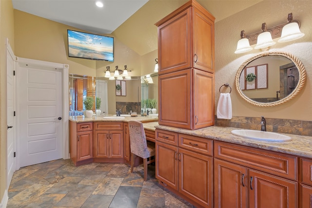 bathroom featuring vanity and vaulted ceiling