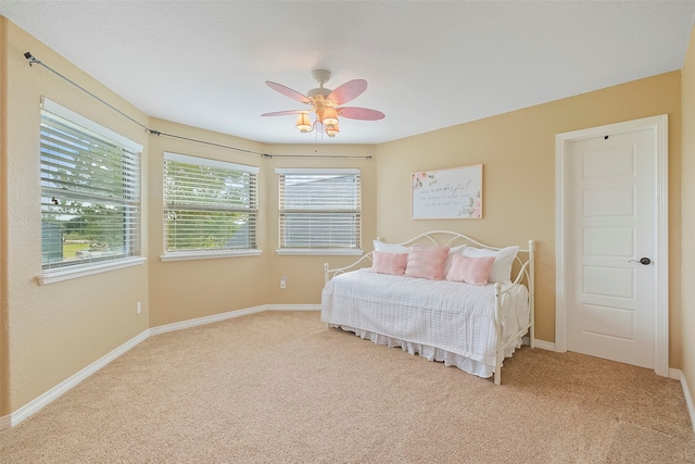 carpeted bedroom featuring ceiling fan