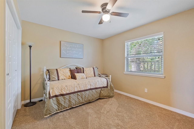 bedroom featuring carpet flooring, ceiling fan, and a closet