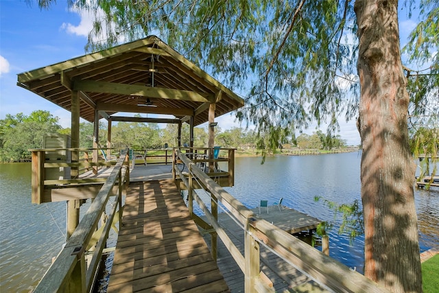 view of dock with a gazebo and a water view