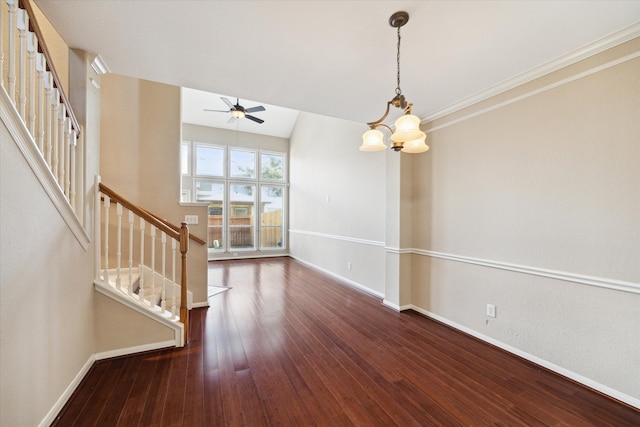 interior space featuring dark wood-type flooring, ceiling fan with notable chandelier, and crown molding