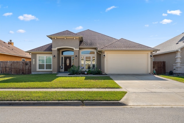 view of front of home featuring a front yard and a garage