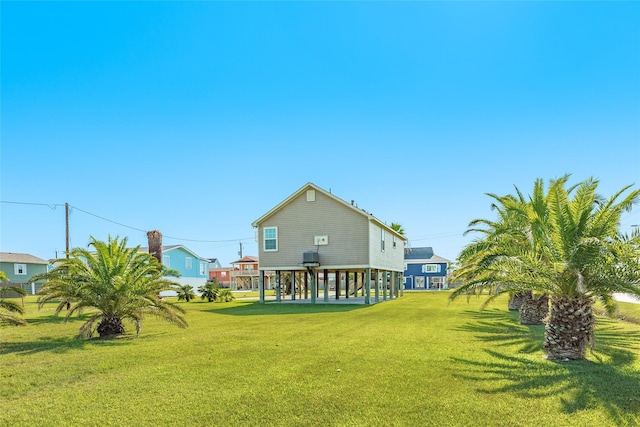16534 Francis Drake Rd, Jamaica Beach, TX 77554 - rear view of house featuring a lawn