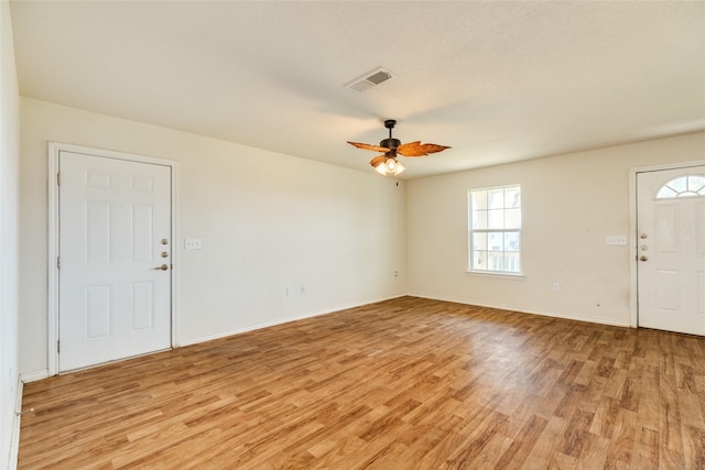 16534 Francis Drake Rd, Jamaica Beach, TX 77554 - foyer with visible vents, a ceiling fan, light wood finished floors, and baseboards