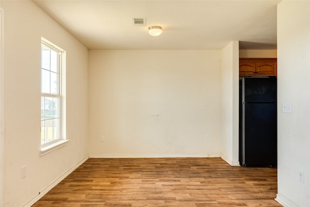 spare room featuring light wood-type flooring