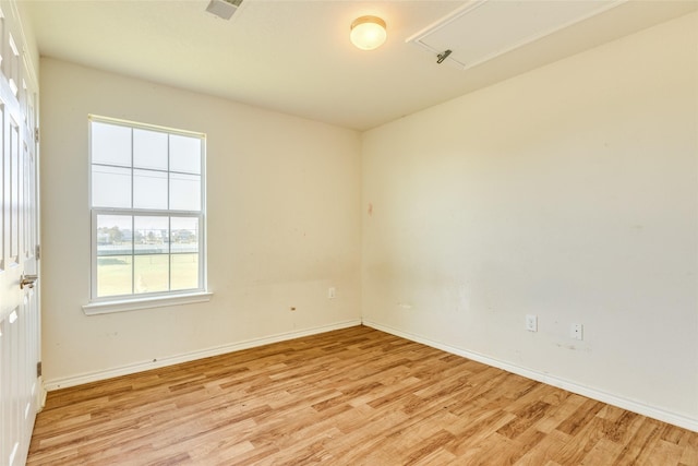16534 Francis Drake Rd, Jamaica Beach, TX 77554 - spare room featuring baseboards, visible vents, attic access, and light wood-style floors