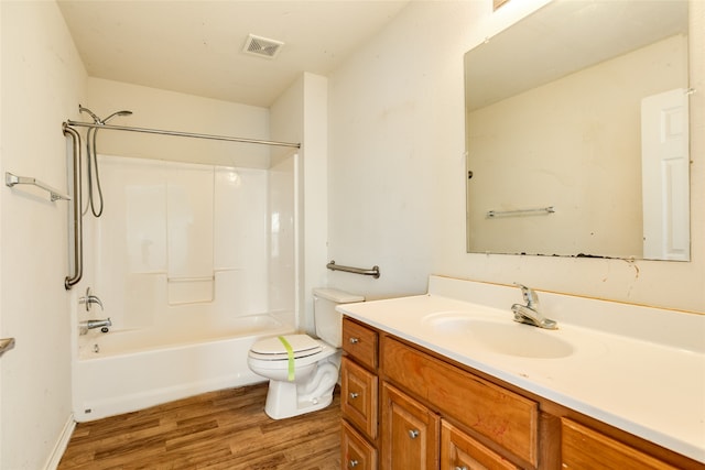 full bathroom featuring vanity, toilet, wood-type flooring, and shower / washtub combination