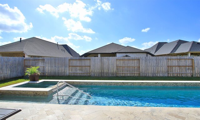 view of pool with an in ground hot tub