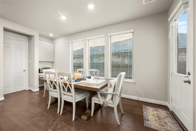 dining room with plenty of natural light and dark hardwood / wood-style flooring