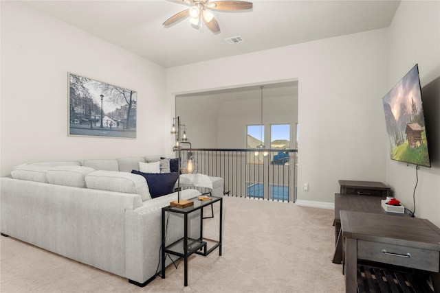 living room with ceiling fan and light colored carpet