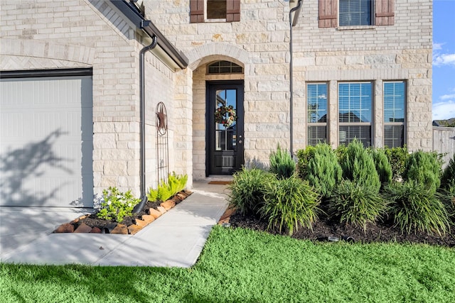 view of exterior entry featuring a garage