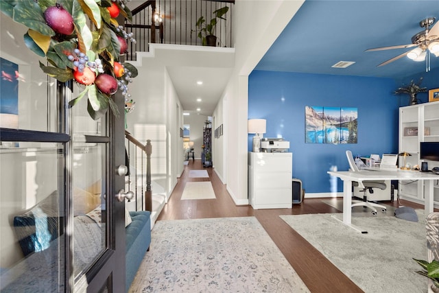 interior space with ceiling fan and dark hardwood / wood-style floors