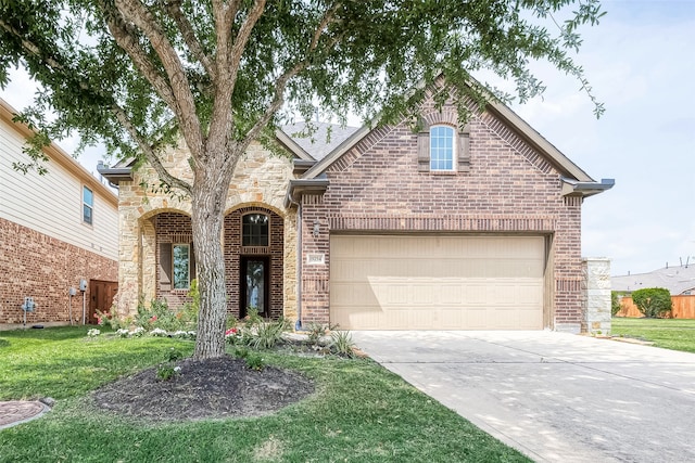 view of front of property with a front yard and a garage