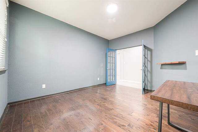 empty room with wood-type flooring