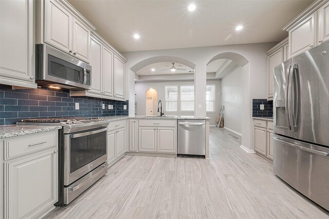 kitchen featuring light hardwood / wood-style floors, stainless steel appliances, sink, and white cabinets