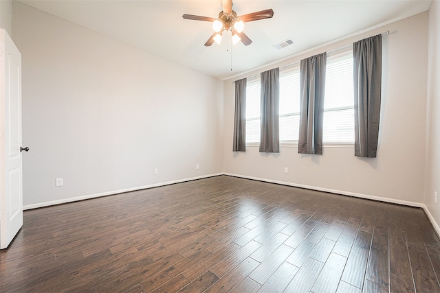 spare room featuring dark wood-type flooring and ceiling fan