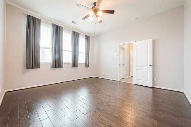 spare room with ceiling fan and dark hardwood / wood-style flooring