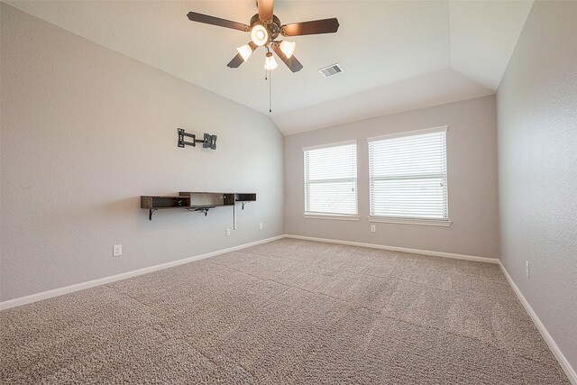 spare room featuring ceiling fan, carpet flooring, and vaulted ceiling