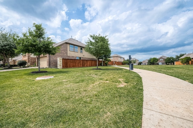 view of side of home featuring a garage and a lawn