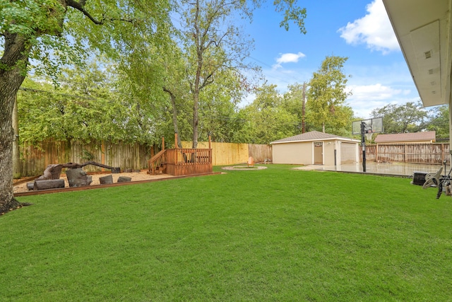 view of yard with a wooden deck and an outdoor structure