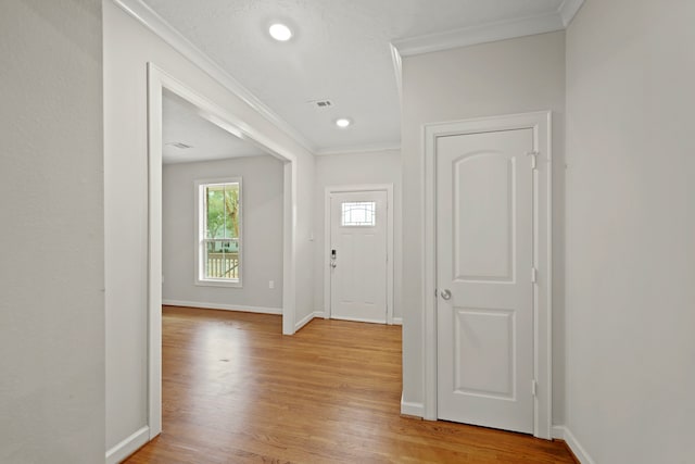 entryway featuring light hardwood / wood-style flooring and crown molding