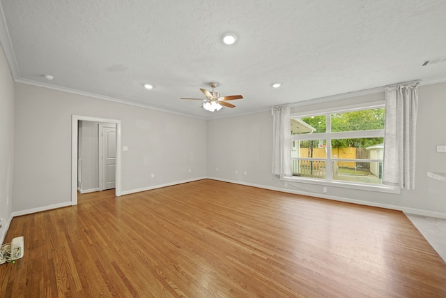 spare room featuring ornamental molding, a textured ceiling, light wood-type flooring, and ceiling fan