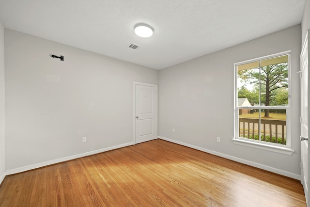 spare room with hardwood / wood-style floors