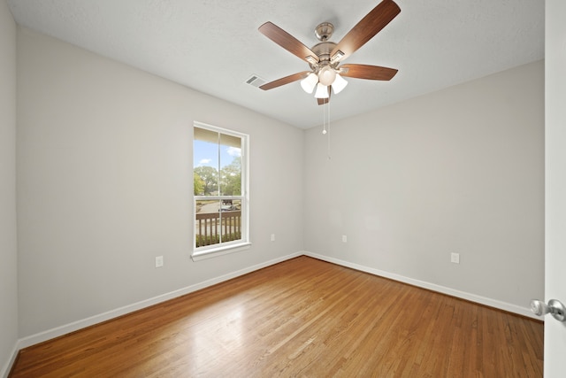 empty room with light hardwood / wood-style floors and ceiling fan