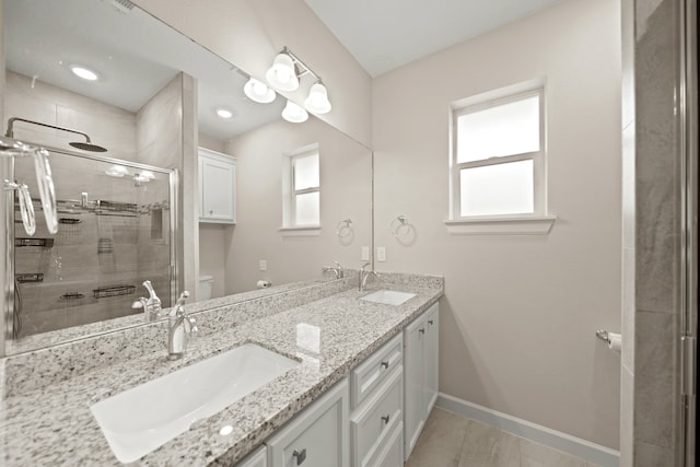 bathroom featuring vanity, a shower with shower door, toilet, and plenty of natural light