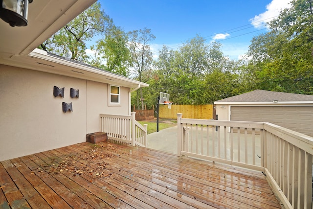 wooden terrace with a garage and an outbuilding