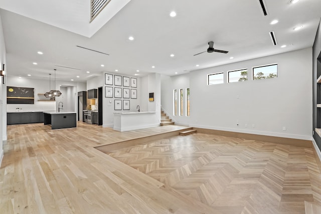 unfurnished living room featuring ceiling fan