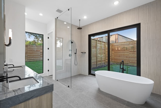 bathroom with vanity and separate shower and tub