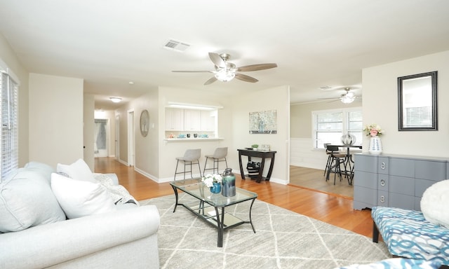 living room with ceiling fan and hardwood / wood-style floors